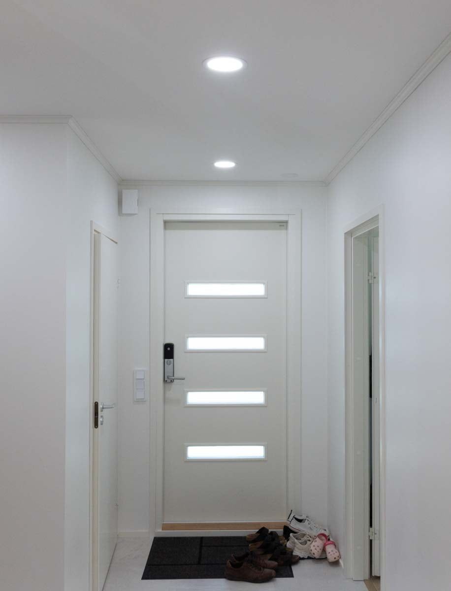 Entrance hall illuminated by Plafondi 160t. The control switches are easily accessible next to the entrance if manual operation is required. LedStore.fi
